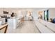 Open concept kitchen with gray cabinets, granite countertops, and modern appliances at 13357 Tropical Breeze Way, Hudson, FL 34669