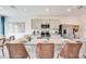Bright kitchen with gray cabinets, granite island, modern appliances, and bar stool seating at 13357 Tropical Breeze Way, Hudson, FL 34669