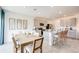 Open concept kitchen and dining area with gray cabinets and a granite island at 13357 Tropical Breeze Way, Hudson, FL 34669