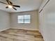 This bedroom features neutral walls, wood-look flooring, a ceiling fan and a window at 1361 Overlea St, Clearwater, FL 33755