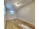 Bright bedroom with wood-look floors and a window providing natural light at 1361 Overlea St, Clearwater, FL 33755
