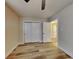 This bedroom features neutral walls, wood-look flooring and a double door closet at 1361 Overlea St, Clearwater, FL 33755
