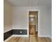 Hallway with wood-look floors leads to rooms, featuring modern trim and doors at 1361 Overlea St, Clearwater, FL 33755