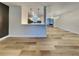 Spacious area featuring wood-look floors, modern lighting, and an open view to the kitchen at 1361 Overlea St, Clearwater, FL 33755