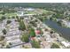 Aerial view of home with community park, lake, baseball fields and residential streets nearby at 1428 Chesterfield Dr, Dunedin, FL 34698