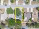 An aerial view shows the property lines, mature trees, and neighborhood streets at 1428 Chesterfield Dr, Dunedin, FL 34698