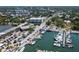 Stunning aerial view of a marina with boats, parking, and nearby buildings surrounded by lush greenery at 1428 Chesterfield Dr, Dunedin, FL 34698