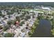 Aerial view of the property in a residential neighborhood with a nearby lake at 1428 Chesterfield Dr, Dunedin, FL 34698