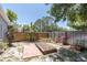 Serene backyard with lush tropical plants, a garden bed, and a wooden fence, creating a peaceful outdoor retreat at 1428 Chesterfield Dr, Dunedin, FL 34698