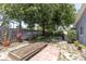 Backyard with a raised garden bed and mature trees that provide a cool, shaded area at 1428 Chesterfield Dr, Dunedin, FL 34698