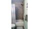 Modern bathroom features stylish gray tiled shower with a shower curtain and updated fixtures at 1428 Chesterfield Dr, Dunedin, FL 34698