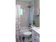 Bright bathroom with a tub and shower featuring marble style tile and a modern white vanity at 1428 Chesterfield Dr, Dunedin, FL 34698