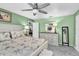 Well-lit bedroom with a floral bedding and an ensuite bathroom is an ideal retreat for relaxation and rest at 1428 Chesterfield Dr, Dunedin, FL 34698