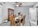 A cozy dining room with a wooden table, chairs, and a vintage display cabinet at 1428 Chesterfield Dr, Dunedin, FL 34698