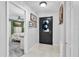 Bright entryway with neutral tile flooring and views into the bedroom at 1428 Chesterfield Dr, Dunedin, FL 34698