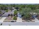 An exterior street view shows the well-maintained home with a large mature tree in the yard at 1428 Chesterfield Dr, Dunedin, FL 34698