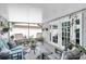 Relaxing screened porch with cozy seating, offering an ideal space for outdoor enjoyment at 1428 Chesterfield Dr, Dunedin, FL 34698