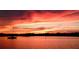 Beautiful sunset over the water with a sailboat silhouetted on the calm sea at 1428 Chesterfield Dr, Dunedin, FL 34698