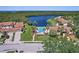Aerial view showcases a community pool surrounded by lush landscaping near the waterfront at 14926 Feather Cove Rd, Clearwater, FL 33762