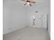 Spacious bedroom featuring neutral carpet, high ceilings, and a ceiling fan at 14926 Feather Cove Rd, Clearwater, FL 33762