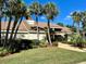 Landscaped front yard and charming exterior with a paved walkway leading to the entrance at 14926 Feather Cove Rd, Clearwater, FL 33762