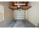 A clean and empty single car garage featuring a white garage door and concrete floor at 14926 Feather Cove Rd, Clearwater, FL 33762