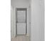 A stacked white washer and dryer in an open, bright laundry closet at 14926 Feather Cove Rd, Clearwater, FL 33762