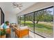 Inviting sunroom with tile flooring and beautiful backyard views through large sliding glass windows at 14926 Feather Cove Rd, Clearwater, FL 33762