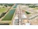New construction aerial showcases homes underway alongside tranquil ponds, roads and ready-to-build lots at 15055 Zircon Red Dr, Wimauma, FL 33598