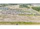 Aerial view of an expansive residential community featuring a mix of completed homes and vacant lots at 15055 Zircon Red Dr, Wimauma, FL 33598