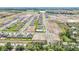 New construction aerial view of a residential community, highlighting street layout and green spaces at 15055 Zircon Red Dr, Wimauma, FL 33598