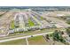 Aerial view showcases the community layout with well-spaced homes, green spaces, and easy road access at 15055 Zircon Red Dr, Wimauma, FL 33598