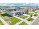 New construction home featuring landscaped front yard, covered porch, and two-car garage at 15055 Zircon Red Dr, Wimauma, FL 33598