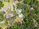 Aerial view showing home with a pool amidst lush greenery and neighboring houses at 1603 Cottagewood Dr, Brandon, FL 33510