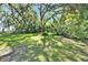 Serene backyard featuring lush greenery and a red bench, creating a peaceful and relaxing outdoor space at 1603 Cottagewood Dr, Brandon, FL 33510