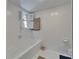 Bathroom with white tile, shutters, and tub at 1603 Cottagewood Dr, Brandon, FL 33510