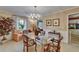 Charming dining room features a glass-top table, floral chairs, chandelier, and wainscoting detail at 1603 Cottagewood Dr, Brandon, FL 33510