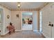Charming entryway with brick flooring, a chandelier, and floral wallpaper accents showcases timeless elegance at 1603 Cottagewood Dr, Brandon, FL 33510