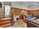 Cozy living area with wood paneling, comfortable seating, and a staircase leading to another level at 1603 Cottagewood Dr, Brandon, FL 33510