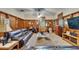 Inviting living room with wood paneling, a large sofa, and a dedicated workspace area at 1603 Cottagewood Dr, Brandon, FL 33510