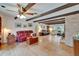 Inviting living room boasts beamed ceilings, a brick fireplace, and hardwood floors, perfect for entertaining at 1603 Cottagewood Dr, Brandon, FL 33510
