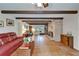Expansive living room with wood beams, brick fireplace, and hardwood flooring offers a cozy and inviting atmosphere at 1603 Cottagewood Dr, Brandon, FL 33510
