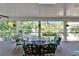 Screened-in patio with outdoor seating, offering a relaxing view of the backyard and pool at 1603 Cottagewood Dr, Brandon, FL 33510