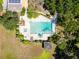 Aerial view of a large pool area with a landscaped garden and pool house at 1603 Cottagewood Dr, Brandon, FL 33510