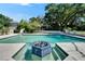 Inviting pool featuring a fountain and surrounded by lush greenery, perfect for relaxation and outdoor enjoyment at 1603 Cottagewood Dr, Brandon, FL 33510