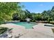 Refreshing swimming pool with diving board and pool house surrounded by landscaping at 1603 Cottagewood Dr, Brandon, FL 33510