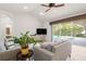 Comfortable living room featuring stylish gray couches, vaulted ceilings, and sliding glass doors to the pool area at 17206 Emerald Chase Dr, Tampa, FL 33647