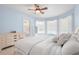 Serene main bedroom with large windows, soft lighting, and a calming blue color scheme at 17206 Emerald Chase Dr, Tampa, FL 33647
