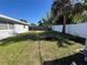 A spacious backyard with mature trees and a fenced perimeter at 1748 Ragland Ave, Clearwater, FL 33765