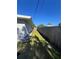 Long backyard features well-maintained grass and a tall wooden fence at 1748 Ragland Ave, Clearwater, FL 33765